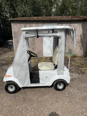 Refurbished Grasshopper Senior Pro golf buggy with white bodywork and roll-up side covers